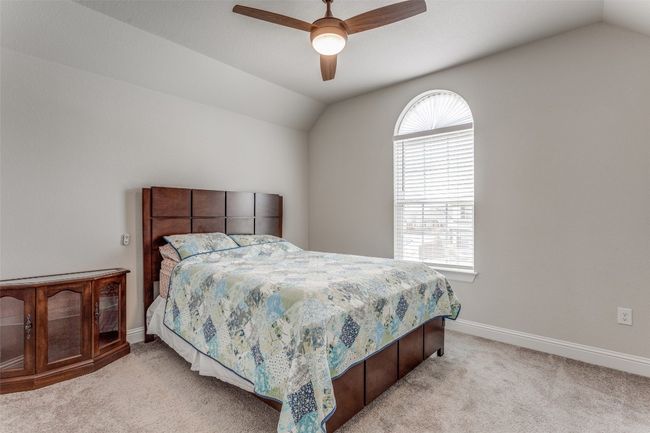 Bedroom featuring vaulted ceiling, light colored carpet, and a ceiling fan | Image 14