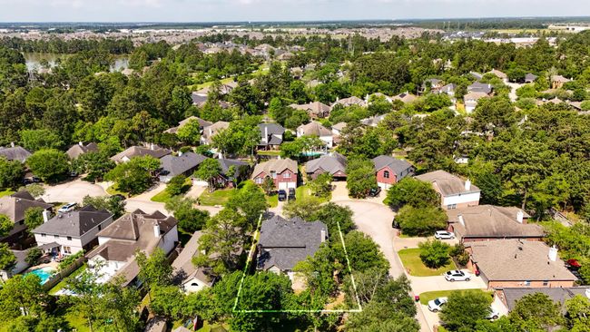 This aerial view captures the home’s prime corner lot location within Windrose, with the lush golf course visible in the distance. It offers a clear sense of space and proximity to the community's desirable amenities. | Image 39