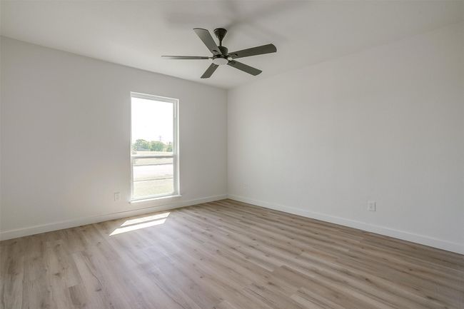 Spare room featuring light wood finished floors and ceiling fan | Image 16