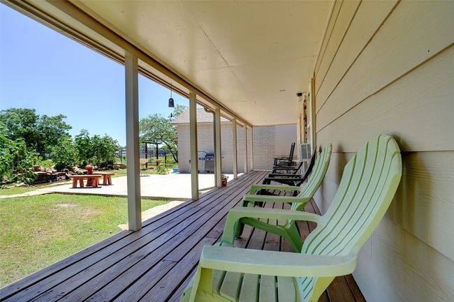 Deck with a yard and a patio area with southing water feature | Image 22
