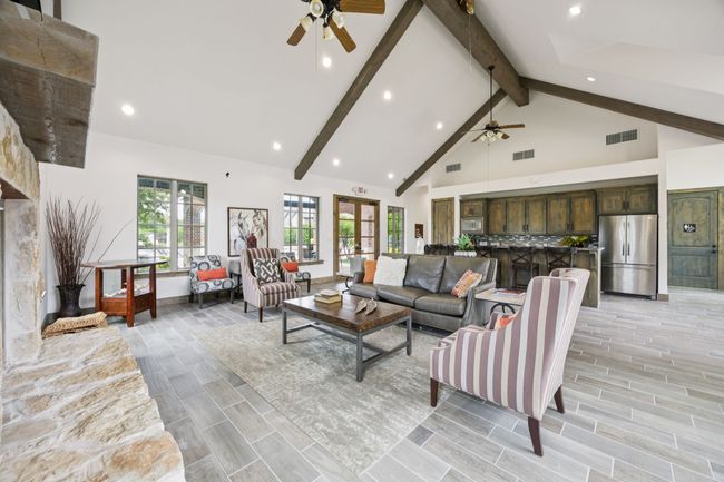 Living room featuring ceiling fan, beamed ceiling, high vaulted ceiling, recessed lighting, and wood finish floors | Image 30