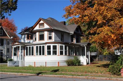 Victorian house featuring a front lawn and a sunroom | Image 1