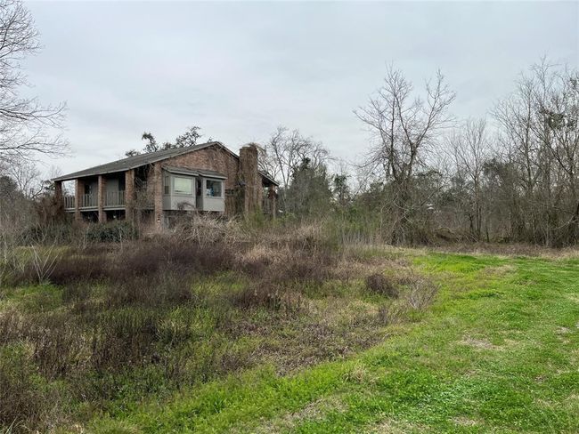 We're nearing the back of the property. The driveway curves to the old house that was flooded in Harvey. | Image 12