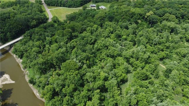 Aerial overview of property's location featuring a large body of water and a heavily wooded area | Image 58