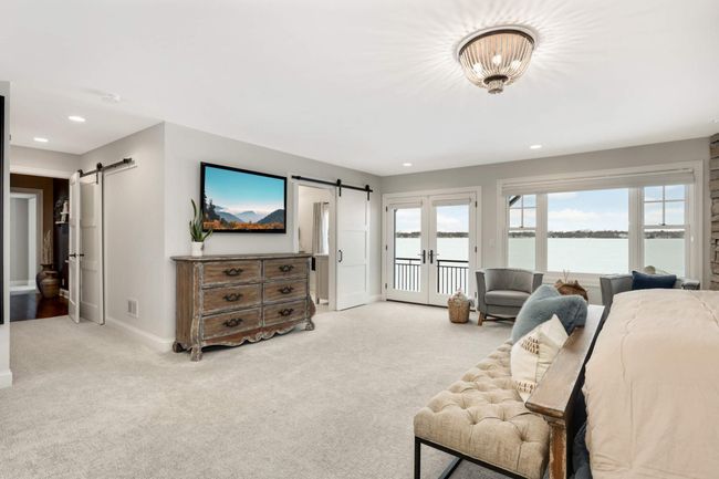 Pair of doors lead to the private master deck overlooking the lake | Image 25