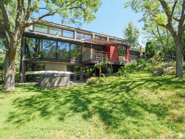 Back of property with a hot tub, a yard, and a deck | Image 5