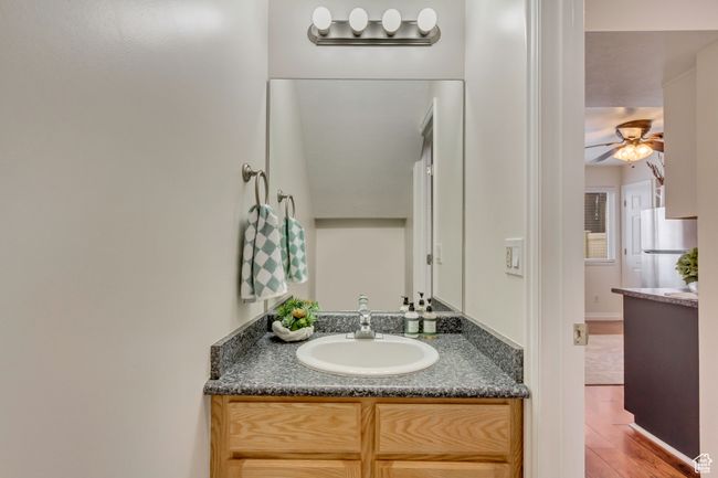 Bathroom featuring a ceiling fan, vanity, and wood finished floors | Image 6