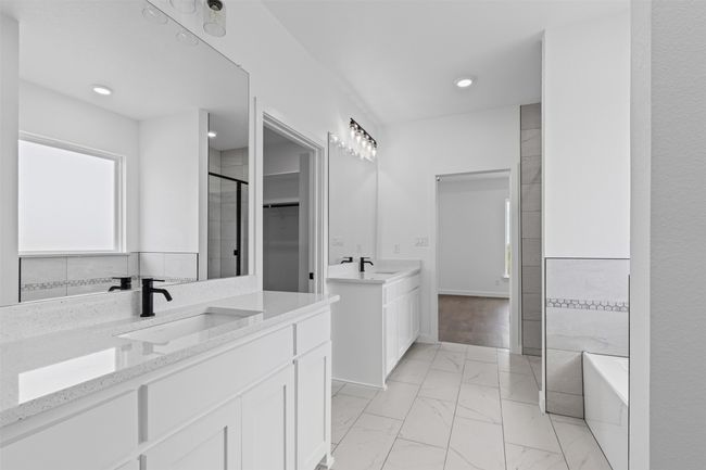 Bathroom featuring two vanities, a shower stall, a sink, and marble finish floor | Image 24
