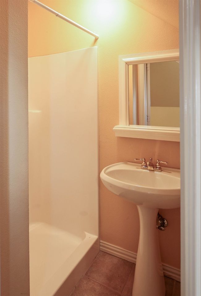 Bathroom featuring tile patterned flooring, baseboards, and a stall shower | Image 24