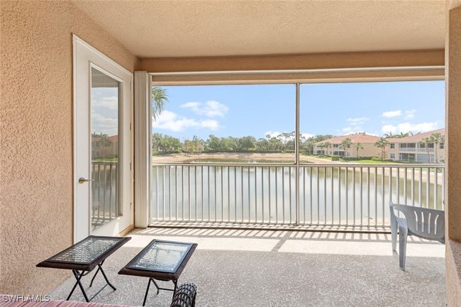 Unfurnished sunroom featuring a wealth of natural light, a textured wall, a textured ceiling, and a water view | Image 29