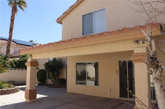 Back of house featuring a patio area, stucco siding, and a tile roof | Image 61