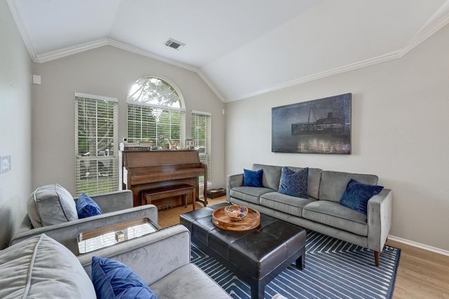Formal Living area featuring wood finished floors, vaulted ceiling, crown molding, and baseboards | Image 12