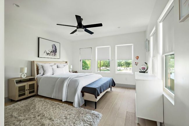 Bedroom featuring light wood-style flooring, baseboards, and ceiling fan | Image 28