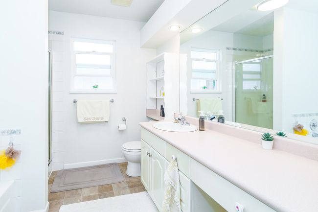 Full bathroom featuring a shower stall, vanity, toilet, baseboards, and recessed lighting | Image 20