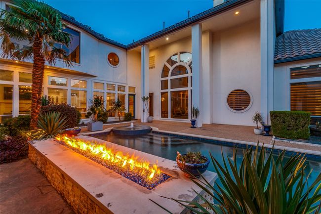 Enjoy the tranquility of warm nights next to the large poolside firepit, the feel the palm trees swaying around you. | Image 33