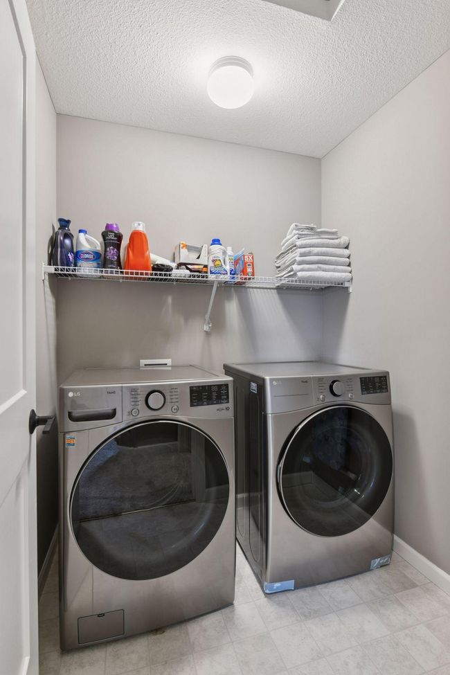 The upper-level laundry room adds everyday convenience. | Image 15