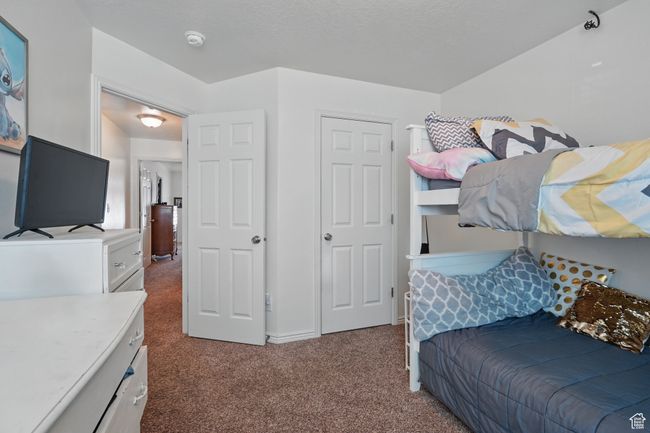Bedroom featuring dark colored carpet | Image 29