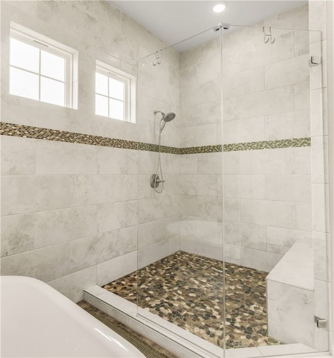 Bathroom featuring a freestanding tub and a stall shower | Image 13