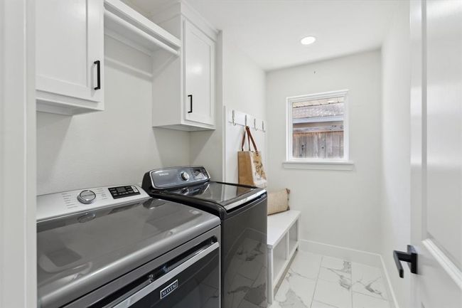 Designed for efficiency, the laundry room offers cabinet storage, a dedicated hanging area, and a mudroom zone to keep things organized. | Image 26