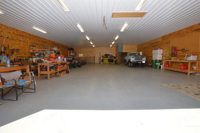 Garage with a workshop area | Image 31