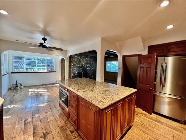 Kitchen open to dining. | Image 10