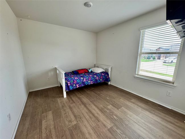 Bedroom with wood finished floors and baseboards | Image 11