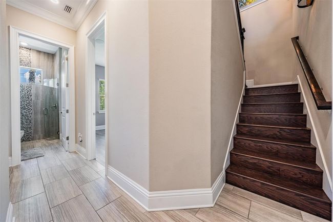 stairs to the upstairs bonus room, full bath, media closet and upstairs lanai | Image 34