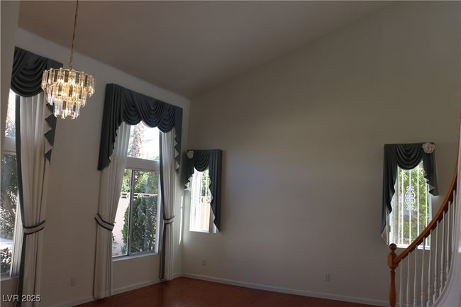 Spare room with wood finished floors, a chandelier, and lofted ceiling | Image 16