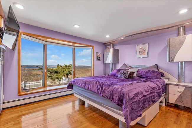Bedroom featuring water views, light wood finished floors and recessed lighting | Image 8