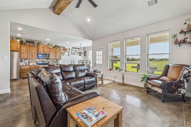 Living room featuring baseboards, concrete flooring, a ceiling fan, and recessed lighting | Image 6