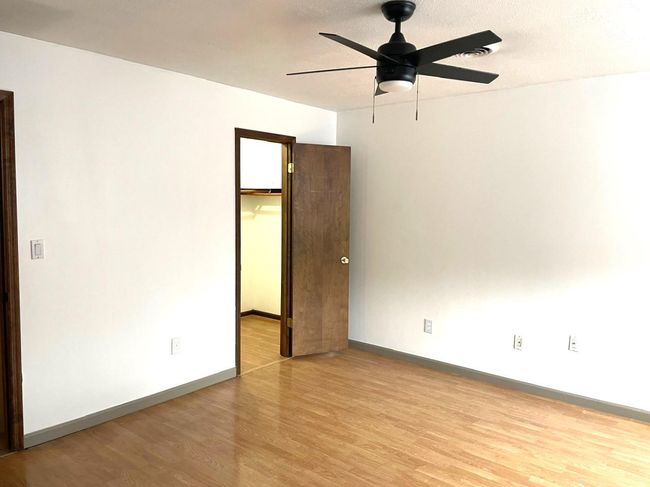 Spare room featuring light wood finished floors and ceiling fan | Image 11