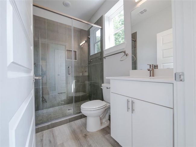 Full bathroom featuring vanity, a shower stall, and wood finished floors | Image 10