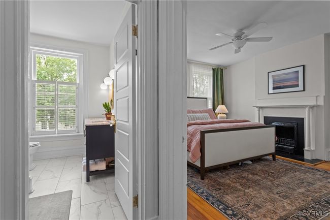 Bedroom with a fireplace, marble finish floor, a ceiling fan, and multiple windows | Image 17