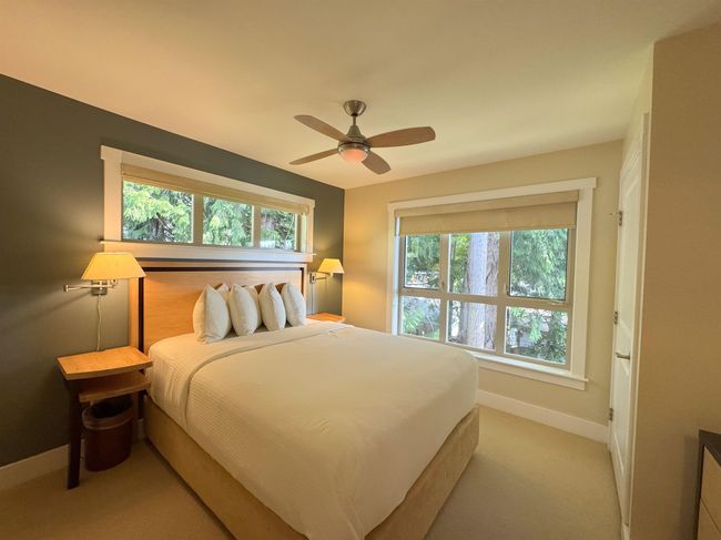 Bedroom with ceiling fan and light carpet | Image 18