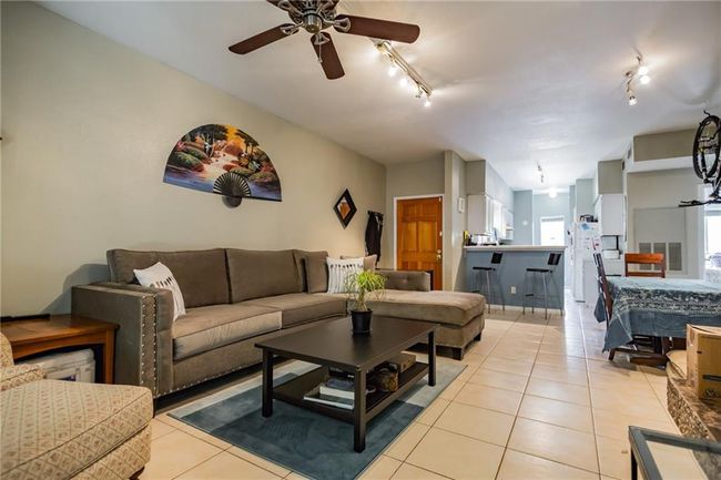 Living area featuring track lighting, light tile patterned flooring, and ceiling fan | Image 20