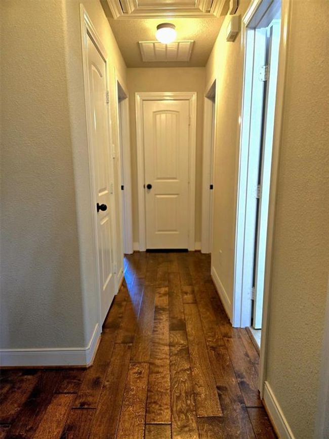The rich wooden flooring creates a warm and inviting atmosphere in the home. | Image 21