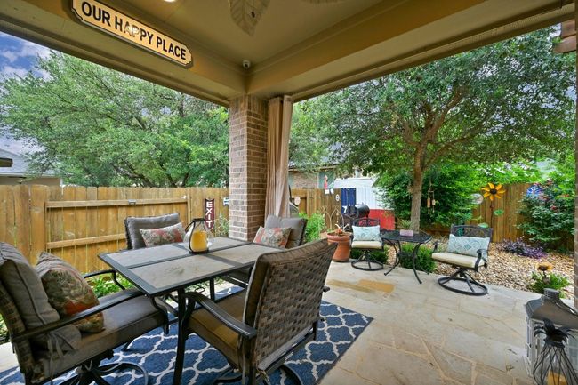 Fenced backyard featuring outdoor dining space and a patio | Image 25