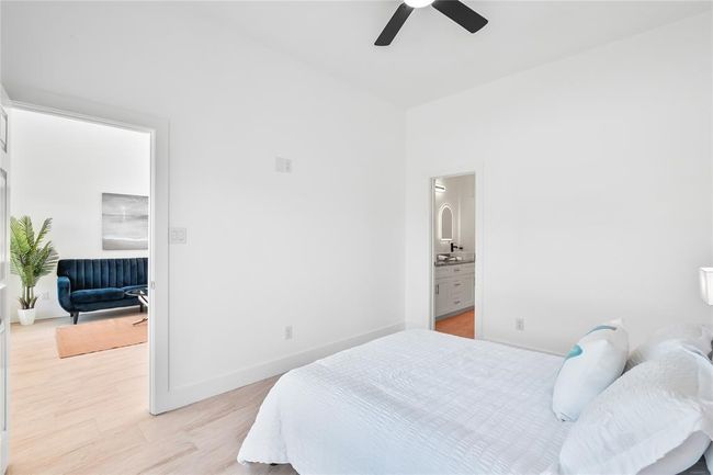 Spacious primary bedroom with ensuite bath and access to a cozy sitting area, perfect for relaxation. | Image 16