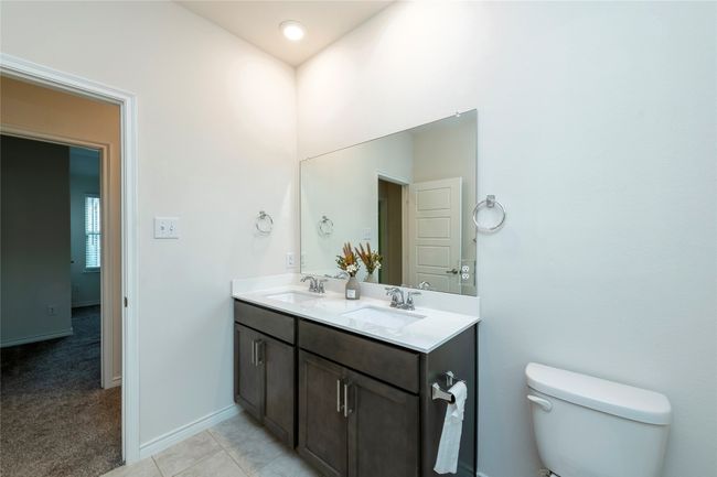 Full bathroom featuring double vanity and light tile patterned floors | Image 27