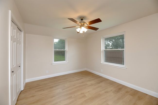 Unfurnished bedroom with light wood-style floors, a closet, baseboards, and ceiling fan | Image 18