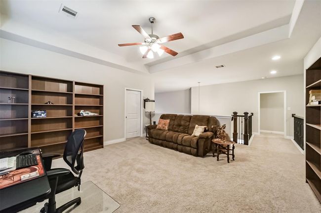 The spacious landing on the second floor is essentially your game room. Offering plenty of room for pool table, shuffleboard or as it is currently as as secondary office space. The door to the left opens to a private media roo, that can be customized to your liking. | Image 16