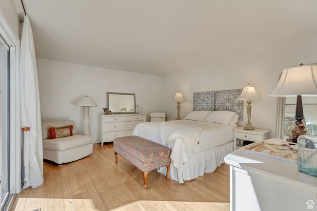 Bedroom with light wood-style flooring | Image 14