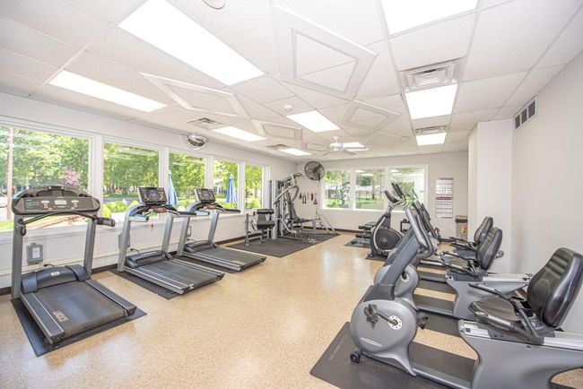 Exercise room with a drop ceiling and ceiling fan | Image 11