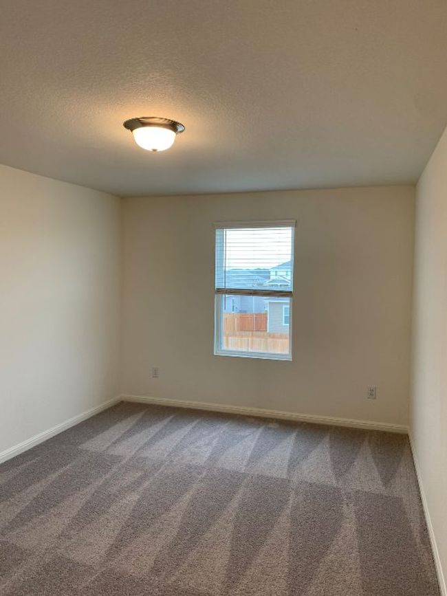 Unfurnished room with dark colored carpet and a textured ceiling | Image 6