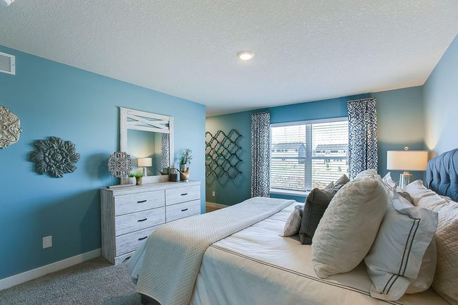 The very generous primary bedroom has plenty of space to fit your dream furniture set. Bedroom fits king-size furniture. Photo of Model Home. Options and colors may vary. Ask Sales Agent for details. | Image 21