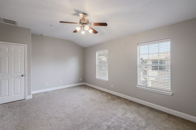 Primary bedroom with plenty of natural light, and a ceiling fan | Image 12