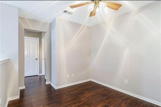 Unfurnished room featuring dark wood-type flooring and ceiling fan | Image 15