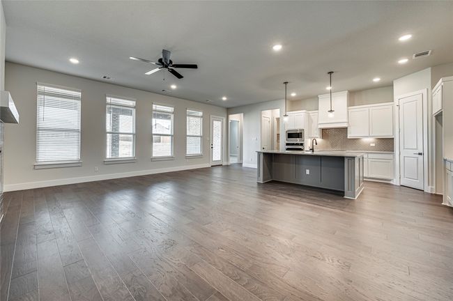Kitchen with open floor plan, appliances with stainless steel finishes, and visible vents | Image 9