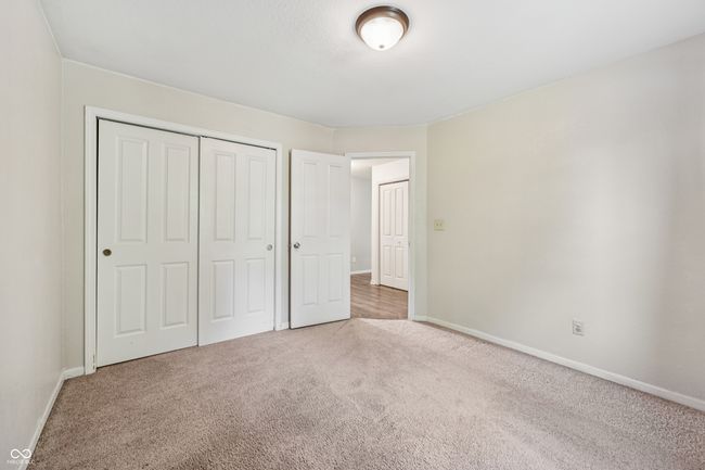 unfurnished bedroom with carpet flooring and a closet | Image 23