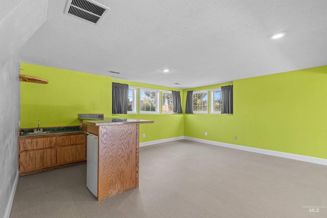 Indoor wet bar with a textured ceiling and recessed lighting | Image 36